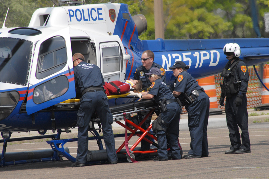 police officers loading person into helicopter